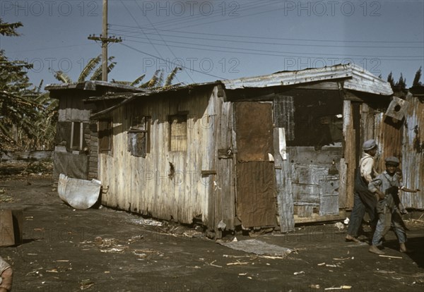 Black migratory workers by a shack, Belle Glade,  1941