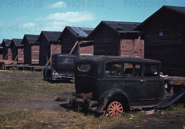 Black migratory workers by a shack, Belle Glade,  1941