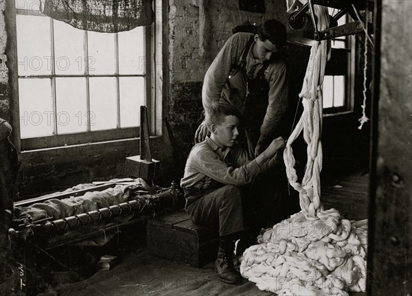 Boy at warping machine. Been there 2 years. Clyde Cotton Mill.  1908