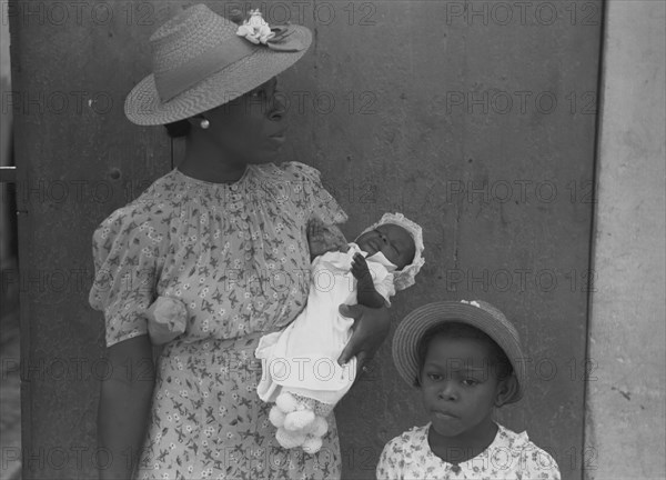 Mother and children waiting on the main street on Sunday 1941