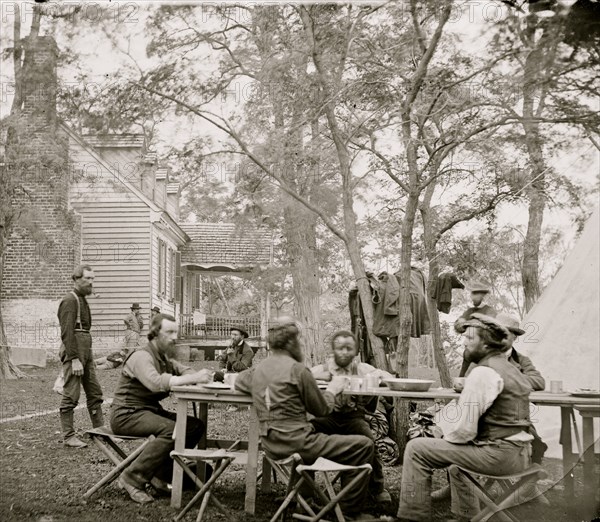 Cumberland Landing, Va. Secret Service men at Foller's House; Black seated as an equal at a table dining 1862