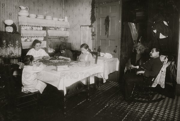 Italian Family picks nuts in their tenement apartment 1911