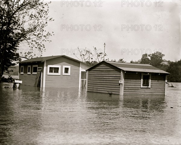 Floodwaters rise around a garage and home 1924