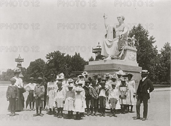 Group of school children in front of statue of George Washington, Washington, D.C. 1899
