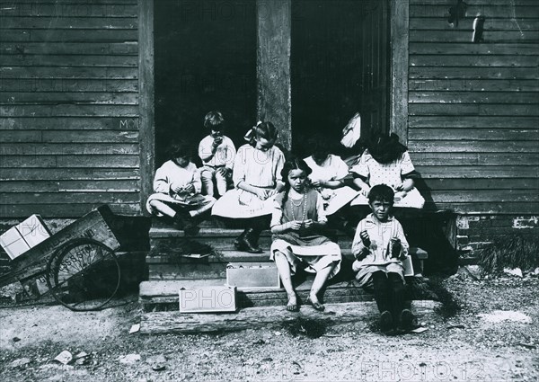 Group working on tags in rear of 196 Highland Street 1912