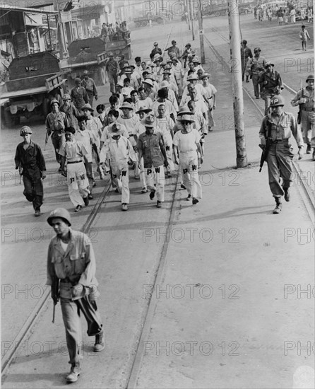 Japanese prisoners of war being guarded by Americans--probably in the Philippines 1944