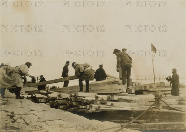 Japanese removing timbers from lighters at Chemulpo for erection of runways 1904