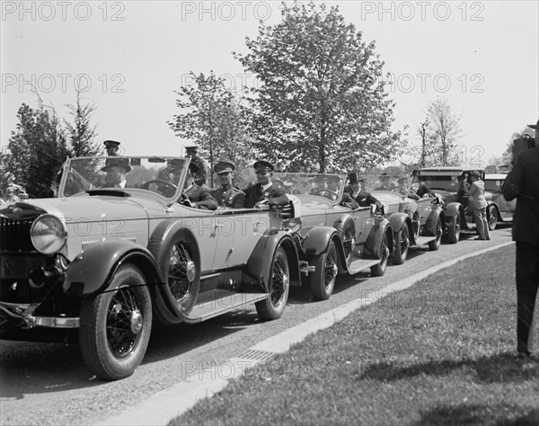 Man photographing line of cars