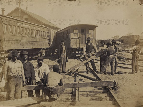 Military railroad operations in northern Virginia: men using levers for loosening rails 1863