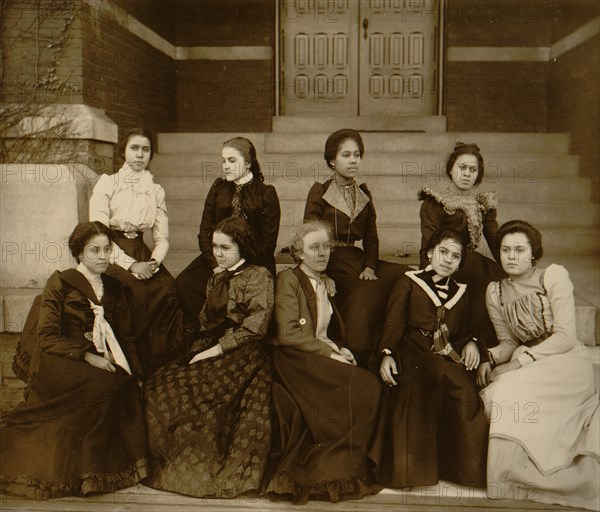 Nine African American women, full-length portrait, seated on steps of a building at Atlanta University, Georgia 1899