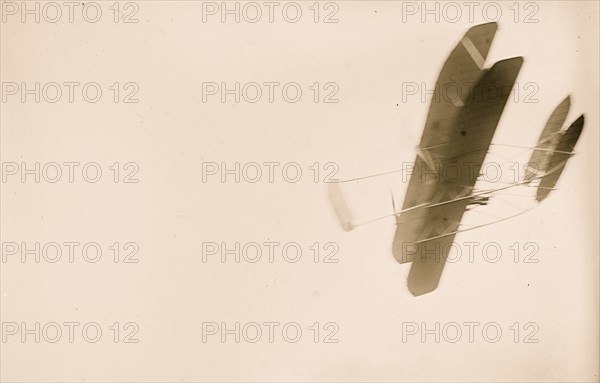 Orville Wright flying in his airplane 1908