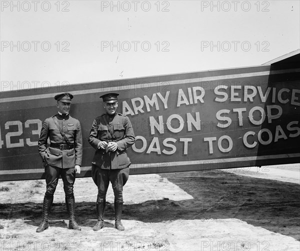 Pilots pose in front of a Plane that they fly coast to coast 1923