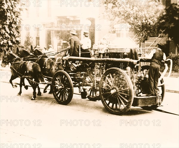 Three firemen on fire engine drawn by three horses, Washington, D.C. 1912