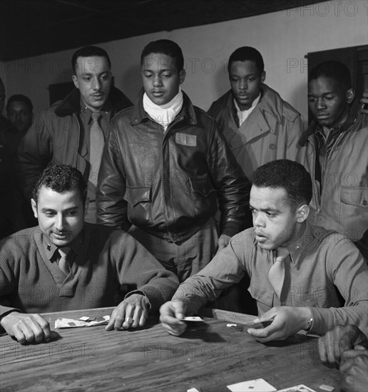 Tuskegee airmen playing cards in the officers' club in the evening 1945