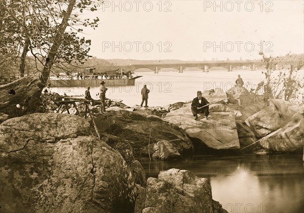 Georgetown ferry-boat carrying wagons, and Aqueduct Bridge beyond, from rocks on Mason's Island 1863