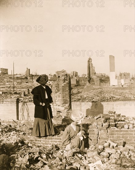 Women pick through the rubble of buildings after the earthquake 1906