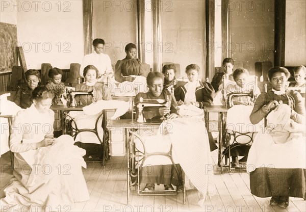 Young women sewing with machines and by hand in the sewing class at the Agricultural and Mechanical College, Greensboro, N.C. 1899