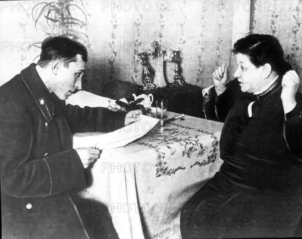 A revenue inspector interviewing a private business woman in 1926 during new economic policy period.