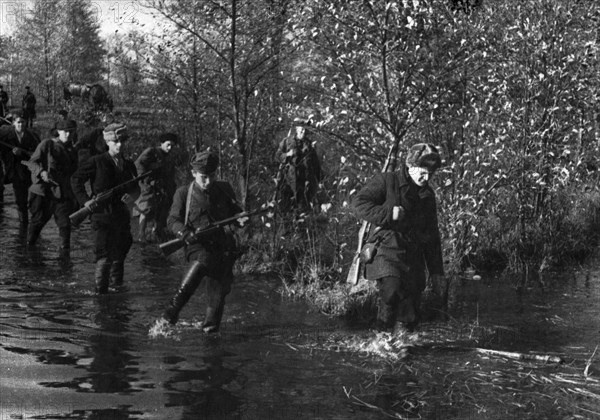 World war 2, byelorussian partisans making their way through forests and marshes.