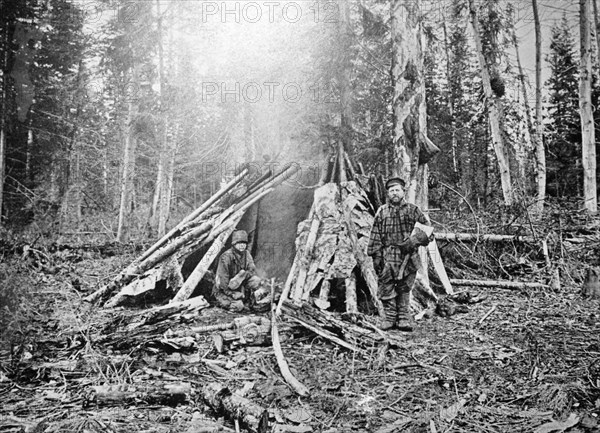 Seasonal workers outside of their hut in siberia, late 19th century russia.