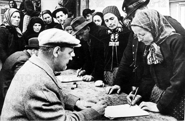 Collective farmers signing the appeal for the conclusion of a five-powers peace pact in romania, 1952.