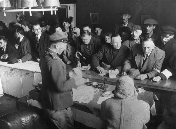 Captain kazakov receiving german civilians in the soviet military commandant's office in weissensee district, 1945.