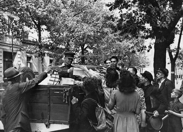 Distributing german newspapers to the population of berlin, 1945 or 1946.