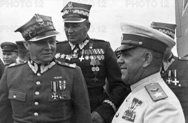 Marshals georgy zhukov and rokossovsky receive highest awards from the polish military, marshal m, rola-zymierski, commander-in-chief of the polish army, zhukov, and colonel-general s, poplawski at the warsaw aerodrome, 1945,world war 2.