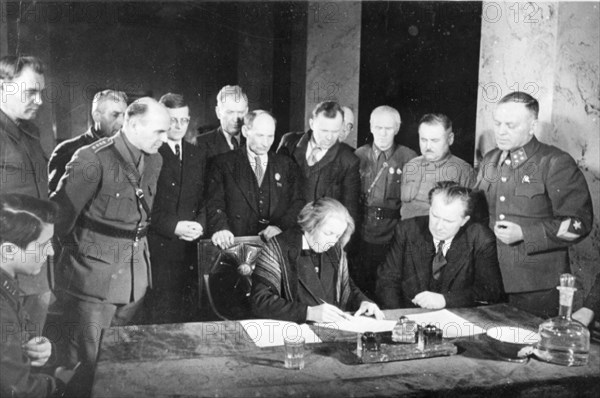 Second all-slav meeting in moscow, signing a message to the slavic peoples: at the table, stelia blagoeva, bulgarian leader (left), also pictured (l, to r,) are polish writer wanda wasilewska, composer dmitri shostakovich, croat leader duro salaj, byelorussian poet yakub kolas, yugoslav poet radule stijenski, leningrad writer nikolai tikhonov, warsaw writer alexandr ioczis, and others.