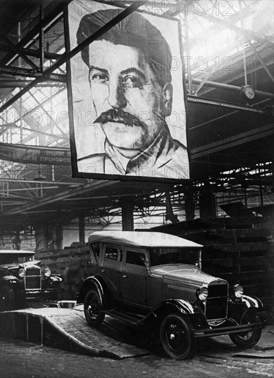 Automobiles (1929 ford type) leaving the assembly line of the molotov auto plant in gorky, ussr, 1930s.