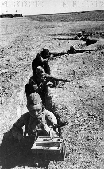 A soviet signalman in a trench in the don valley transmitting a dispatch to the forward edge of defense lines, august 1942.