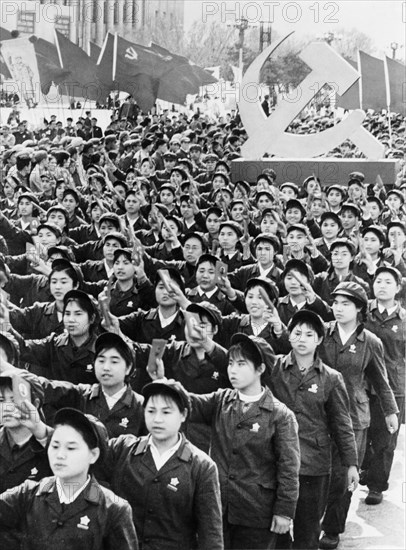 People holding up mao's little red book during a may day demonstration in beijing, china, may 1, 1969, cultural revolution.