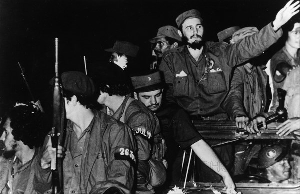 Newly victorious fidel castro ruz entering havana at the head of his revolutionary army, cuba, 1959, juan almeida bosque is behind him in profile.