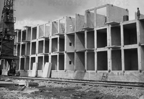 A block of flats being constructed in nowa huta in the krakow province in poland, september 1962, these buildings are being constructed using an experimental method called 'dominoes' from precast units, only six workers are employed at this site.