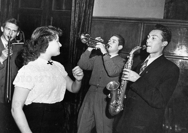 Sixth world festival of youth and students in moscow, july 1957, many orchestras and musical groups of various countries furnished almost continuous performances, a soviet student jazz band preparing for the big event - the music competition.