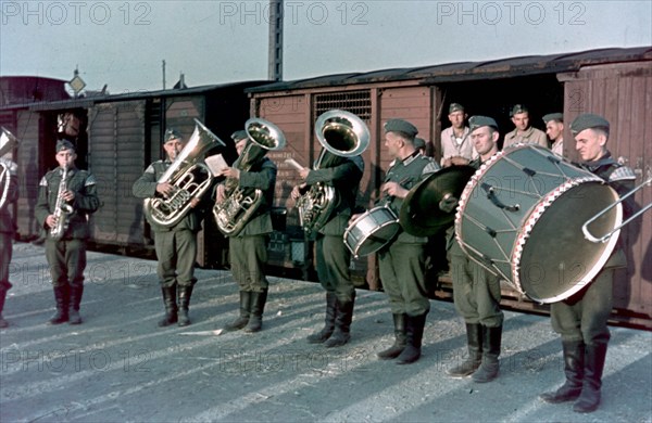 German army band playing at the embarkation point, occupation zone unknown, photo taken by an unknown german soldier.