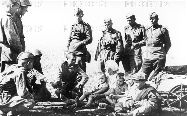 Soviet soldiers with residents of a village liberated from german occupation during the battle of kursk in 1943.