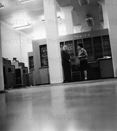 Soviet economist, professor yevsei liberman, with his student assistant in the calculating center of the kharkov turbine works, ussr, 1966, behind them is the ural-4 computer.