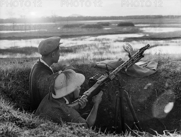 Ant-aircraft machine gunner guarding the skies over the town of vinh, north vietnam, 1965.