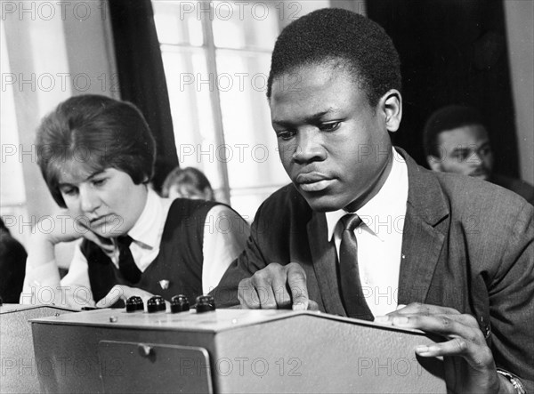 Anna golosok from bryansk and ovuar samuel from kenya in the technical means study room of the order of the red banner of labor technical school of the korinsk state farm in the bryansk oblast, may 1969.