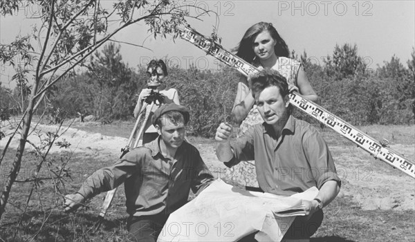 Kiev region, ukrainian ssr, ussr, a group of geodesists measuring the territory at the construction site of the chernobyl nuclear power plant, june 6, 1971, l-r: mikhail chikalovets, vladimir slobodenyuk (second ground), anna lokhanko, lyubov rudenok.