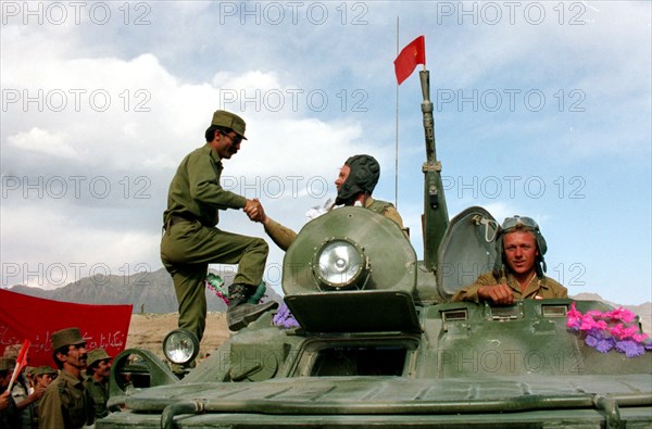 Afghani soldier wishing farewell to the soviet tankmen returning home from afghanistan