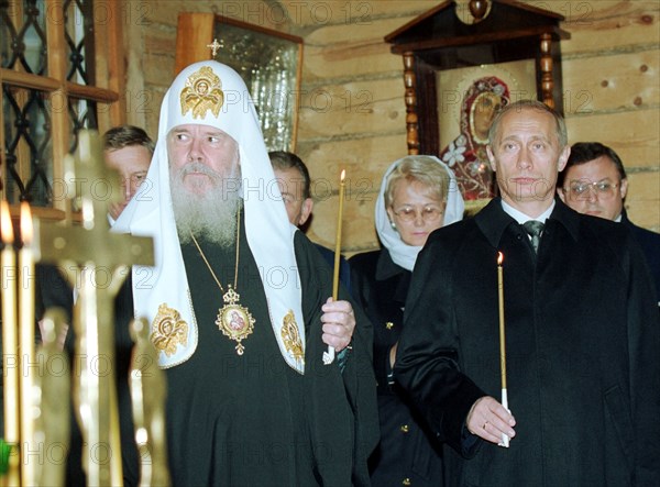 President vladimir putin (right) and the head of the russian orthodox church, patriarch alexy of moscow and all russia attend the funeral service for the victims of the october 25 crash of the il-18 military plane near batumi, georgia,  in  the small chapel of the mother of god of  moscow's cathedral of christ the saviour, today, october 29, 2000.