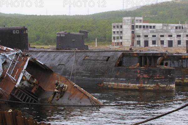 Murmansk region,russia, august 29, 2001, rusty hulls of russian decommissioned submarines pictured being scrapped at belokamenka settlement at kola peninsula (northern russia).