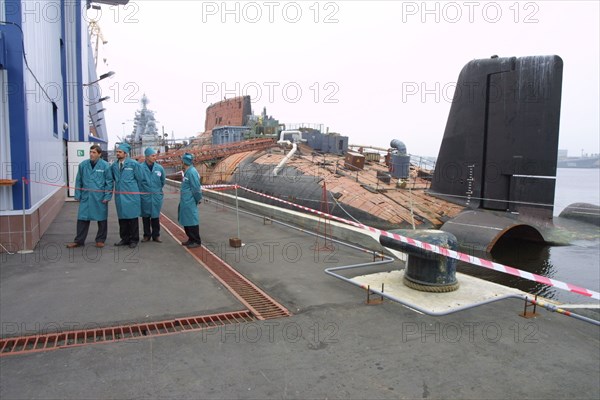 Decommissioned russian 'taifun' (typhoon) strategic nuclear sub moored next to a coastal complex for the discharge of spent nuclear fuel from the reactors of defunct submarines which was inaugurated at the shipbuilding plant zvyozdochka on friday, arkhangelsk region, russia, august 24 2002.