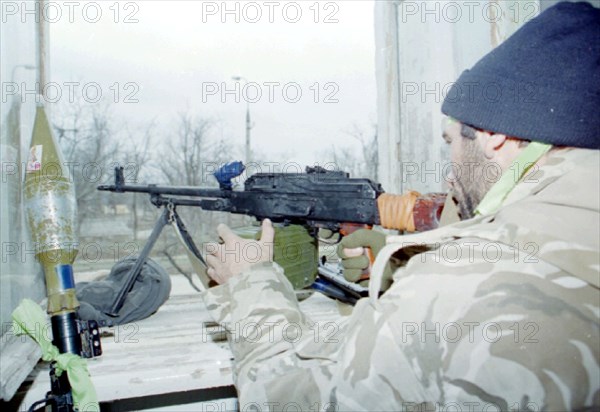 Small groups of chechen rebels are putting up resistance to police and federal troops in the outskirts of grozny, the situation in the centre of grozny is returning to normal, pictured here is one of dudaev militants at combat position in zavodskoy district of the city.