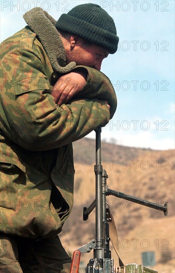 Russian serviceman pictured having a rest after a hard 4-day march his paratroop regiment made from the dzheirakh gorge in ingush republic to the argun gorge in chechnya along a new road to the mountain chechen village of itum-kale on the border with georgia built by military engineers in the rocky terrain in a short time, chechnya, russia, february 29, 2000.