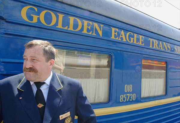 Moscow, russia, june 4, 2007, attendant outside the golden eagle express, the new $25 million fully en-suite private train has been launched by long-distance luxury train operator gw travel limited to serve the world's longest railway line between moscow and vladivostok.