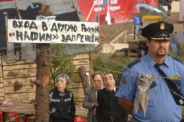 Sign reading 'entrance to the other russia for our people forbidden', a security guard and a puppet of tycoon boris berezovsky, third from left, seen at the summer camp of the pro-putin nashi (our people) youth movement at the lake seliger resort, tver region, russia, july 21, 2007.