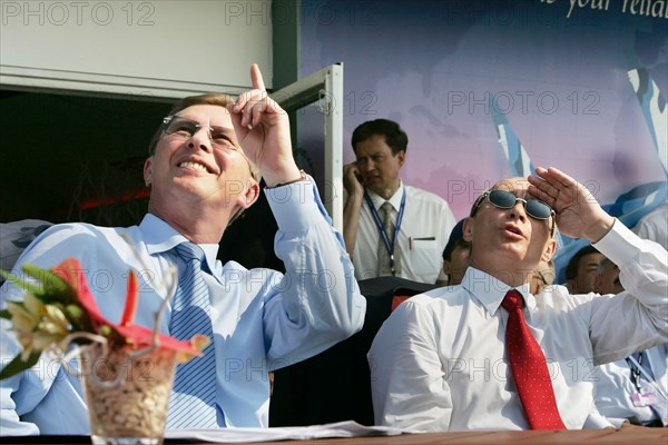 Russian first deputy prime minister sergei ivanov, russian president vladimir putin (l-r) watch the airshow at the opening ceremony of the 8th international aviation & space salon maks 2007  in the town of zhukovsky, moscow region of russia, august 17, 2007.